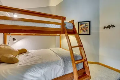 a bedroom with two bunk beds and a bed at 10 Mi to Keystone Resort Cabin with Private Hot Tub in Silverthorne