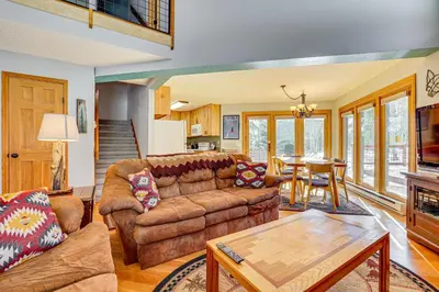 a living room with a couch and a table at 10 Mi to Keystone Resort Cabin with Private Hot Tub in Silverthorne