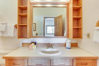 a bathroom with a sink and a mirror at Mtn-View Gem with Community Perks in Silverthorne! in Silverthorne