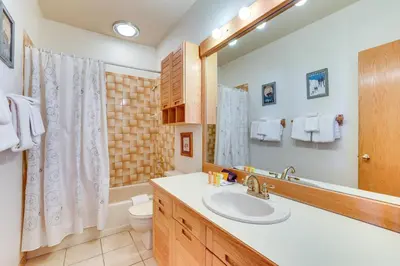 a bathroom with a sink and a toilet and a mirror at Mtn-View Gem with Community Perks in Silverthorne! in Silverthorne