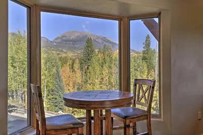 a table and two chairs in a room with a large window at 7 Mi to Copper Mtn Condo with Deck and Stunning Views in Frisco