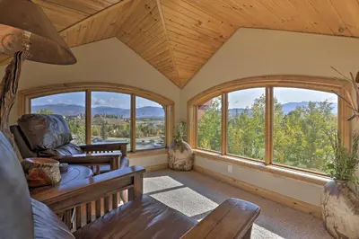 a living room with large windows in a house at 7 Mi to Copper Mtn Condo with Deck and Stunning Views in Frisco