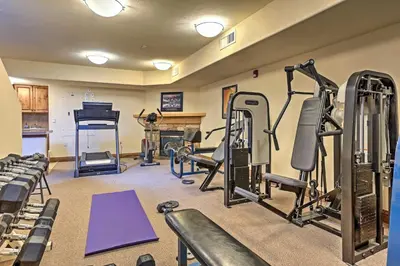 a gym with several tread machines and a piano at 7 Mi to Copper Mtn Condo with Deck and Stunning Views in Frisco
