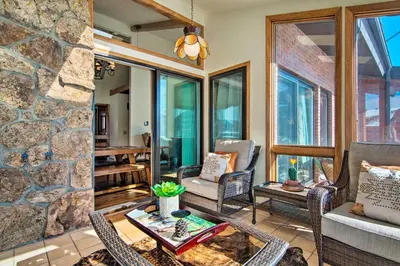 a living room with chairs and a stone wall at 7 Mi to Rocky Mtn NP Updated Estes Park Home in Estes Park