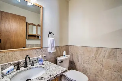 a bathroom with a sink and a toilet and a mirror at 7 Mi to Rocky Mtn NP Updated Estes Park Home in Estes Park