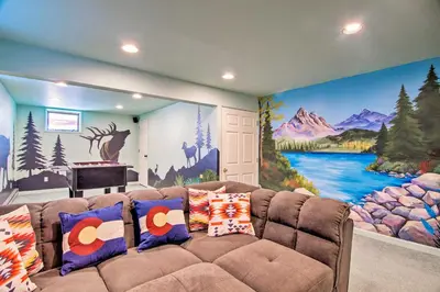 a living room with a couch in front of a mural at 7 Mi to Rocky Mtn NP Updated Estes Park Home in Estes Park