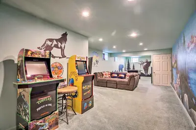 a living room with arcade games and a couch at 7 Mi to Rocky Mtn NP Updated Estes Park Home in Estes Park