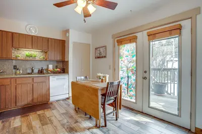 a kitchen with a table and a ceiling fan at Near Red Rocks, Hiking and Skiing Kittredge Condo! in Kittredge
