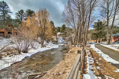 a river with snow on the ground and trees at Near Red Rocks, Hiking and Skiing Kittredge Condo! in Kittredge