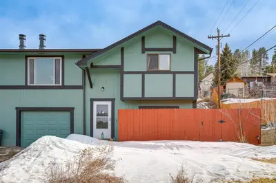a house with an orange fence in front of it at Near Red Rocks, Hiking and Skiing Kittredge Condo! in Kittredge