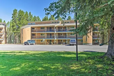 a large building with cars parked in front of it at Condo with Pool and Hot Tub - Walk to DT Winter Park! in Winter Park