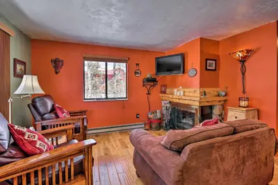 a living room with a couch and a fireplace at Balcony, Fire Pit and Grill Grand Lake Retreat! in Grand Lake