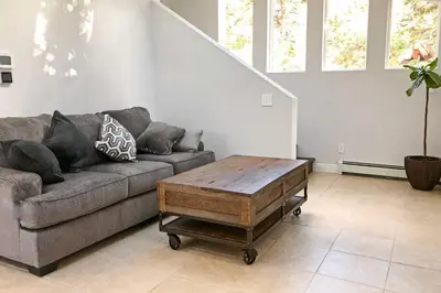 a living room with a couch and a coffee table at 12 Mi to Red Rocks Morrison Home with Deck in Morrison