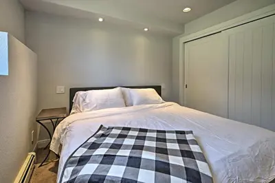 a bedroom with a bed with a checkered blanket on it at 12 Mi to Red Rocks Morrison Home with Deck in Morrison
