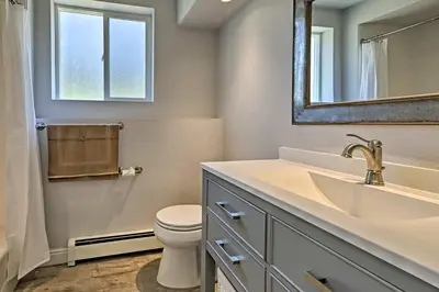 a bathroom with a sink and a toilet and a mirror at 12 Mi to Red Rocks Morrison Home with Deck in Morrison