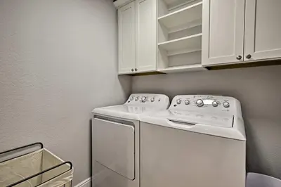 a laundry room with a white washer and dryer at 12 Mi to Red Rocks Morrison Home with Deck in Morrison