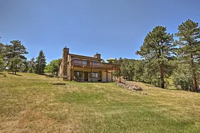 a house on top of a hill with trees at 12 Mi to Red Rocks Morrison Home with Deck in Morrison