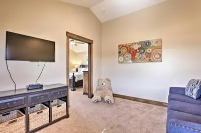 a teddy bear sitting in a living room with a tv at Mtn-View Fraser Home with Hot Tub - Near Skiing! in Fraser
