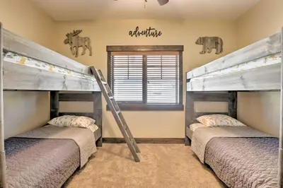 a bedroom with two bunk beds and a window at Mtn-View Fraser Home with Hot Tub - Near Skiing! in Fraser