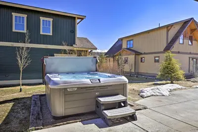 a hot tub sitting in a yard in front of a house at Mtn-View Fraser Home with Hot Tub - Near Skiing! in Fraser
