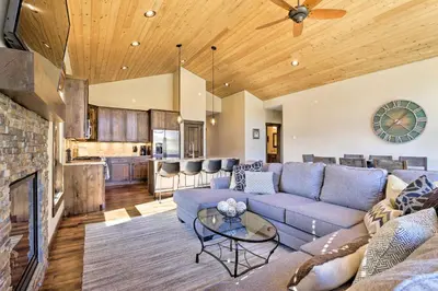 a living room with a couch and a table at Mtn-View Fraser Home with Hot Tub - Near Skiing! in Fraser