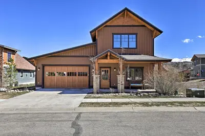 a large wooden house with a garage at Mtn-View Fraser Home with Hot Tub - Near Skiing! in Fraser