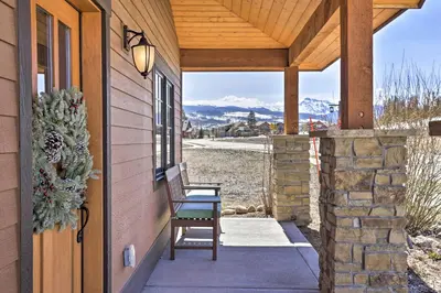 a porch of a house with a chair and a window at Mtn-View Fraser Home with Hot Tub - Near Skiing! in Fraser