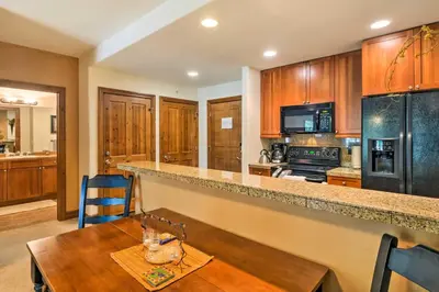 a kitchen with a wooden counter and a wooden table at 4 Mi to Breckenridge Resort Condo with Sauna Access in Breckenridge