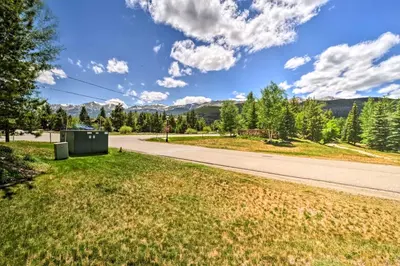a road next to a field of grass and trees at 4 Mi to Breckenridge Resort Condo with Sauna Access in Breckenridge