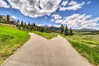 a road in the middle of a field with mountains at 4 Mi to Breckenridge Resort Condo with Sauna Access in Breckenridge