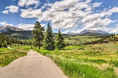 a road through a field with mountains in the background at 4 Mi to Breckenridge Resort Condo with Sauna Access in Breckenridge