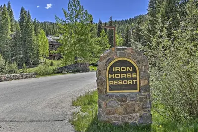 a sign for a iron house resort on the side of a road at Ski-InandSki-Out Winter Park Condo with Hot Tub Access in Winter Park