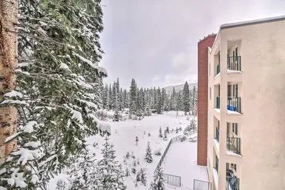 a snow covered yard in front of a building at Ski-InandSki-Out Winter Park Condo with Hot Tub Access in Winter Park