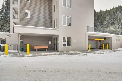 a building with a bench in front of it at Ski-InandSki-Out Winter Park Condo with Hot Tub Access in Winter Park