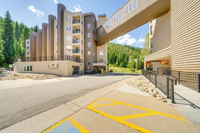 an empty street in front of a building at Ski-InandSki-Out Winter Park Condo with Hot Tub Access in Winter Park