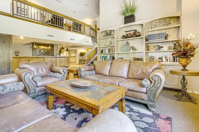 a living room with couches and a coffee table at Ski-InandSki-Out Winter Park Condo with Hot Tub Access in Winter Park