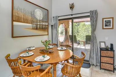 a dining room with a wooden table and chairs at Cabin on Clear Creek A Hobbits Retreat! in Black Hawk