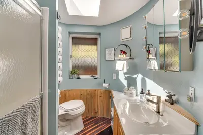 a bathroom with a toilet and a sink at Cabin on Clear Creek A Hobbits Retreat! in Black Hawk
