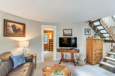 a living room with a couch and a television at Cabin on Clear Creek A Hobbits Retreat! in Black Hawk
