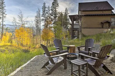a group of chairs sitting around a table in front of a cabin at Winter Park Area Cabin, Hot Tub and Mountain Views! in Fraser