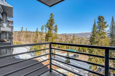 a balcony with a view of the woods at Relax in our hot tub after world class skiing in Silverthorne
