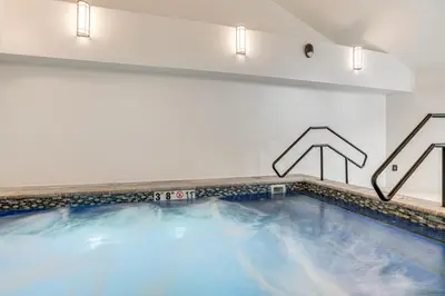 a large swimming pool with blue water in a room at Relax in our hot tub after world class skiing in Silverthorne