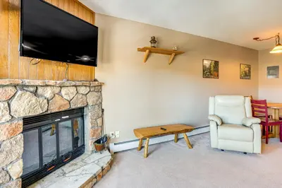 a living room with a fireplace and a flat screen tv at Relax in our hot tub after world class skiing in Silverthorne