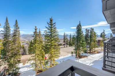 a view from the balcony of a house with trees at Relax in our hot tub after world class skiing in Silverthorne