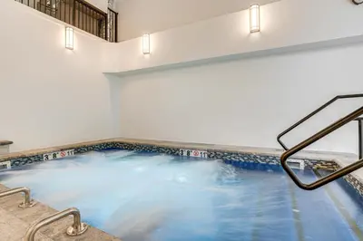 a swimming pool with blue water in a building at Relax in our hot tub after world class skiing in Silverthorne