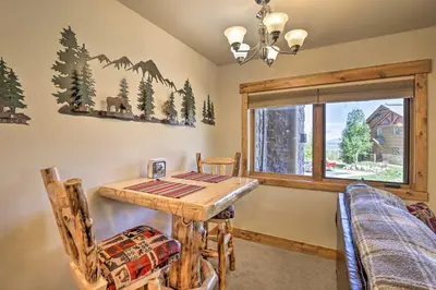 a dining room with a table and chairs and a window at Peaceful Fraser Condo with Patio - by Hiking Trails! in Fraser