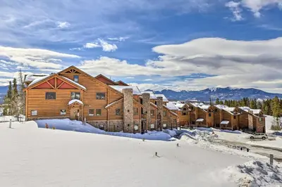 a large wooden lodge in the snow with snow covered at Peaceful Fraser Condo with Patio - by Hiking Trails! in Fraser