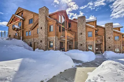 a log home in the winter with snow around it at Peaceful Fraser Condo with Patio - by Hiking Trails! in Fraser