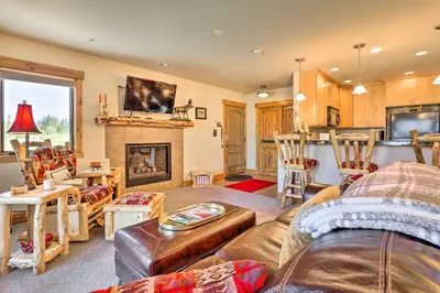 a living room with a couch and a fireplace at Peaceful Fraser Condo with Patio - by Hiking Trails! in Fraser