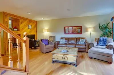 a living room with couches and a coffee table at 2 Mi to Frisco Ski Hill Mountain Home with Hot Tub! in Frisco